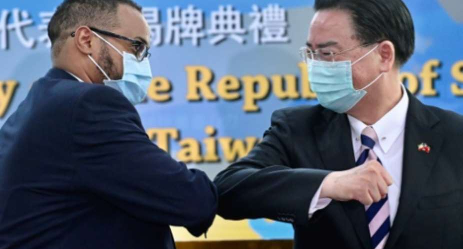Mohamed Hagi left, Somaliland's new representative to Taiwan bumps elbows with Foreign Minister Joseph Wu.  By Sam Yeh AFP