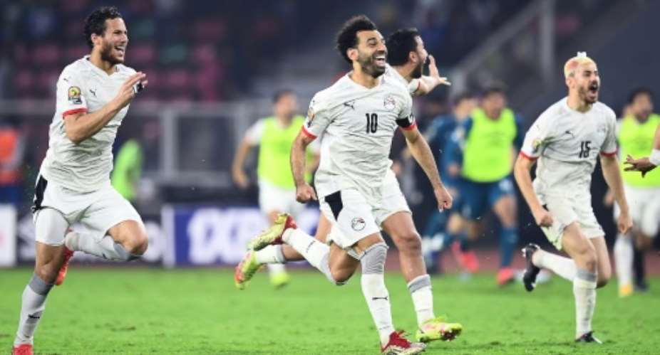 Mohamed Salah C celebrates with teammates after a penalty shoot-out win over hosts Cameroon.  By CHARLY TRIBALLEAU AFP