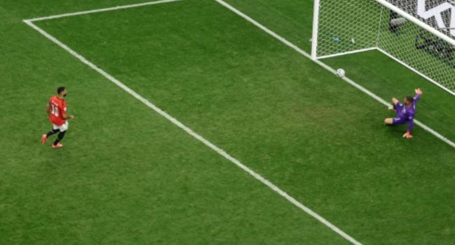 Mohamed Salah (L) stepped up third in the shootout for Egypt and scored a Panenka penalty.  By Aric Becker (AFP)