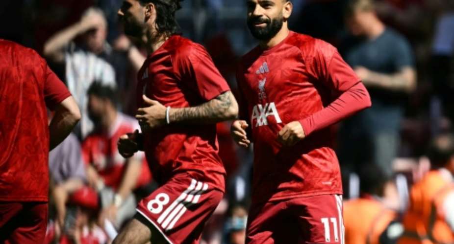 Mohamed Salah (right) warms up before his final game for Liverpool.  By Paul ELLIS (AFP)