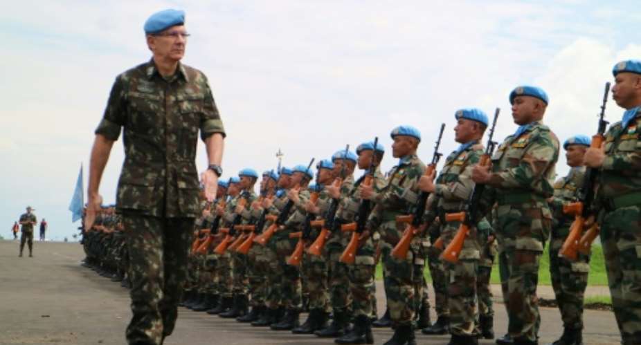 MONUSCO's military commander, Brazilian General Elias Rodrigues Filho, reviews troops at Goma, capital of North Kivu province, in May 2018.  By Alain WANDIMOYI AFPFile