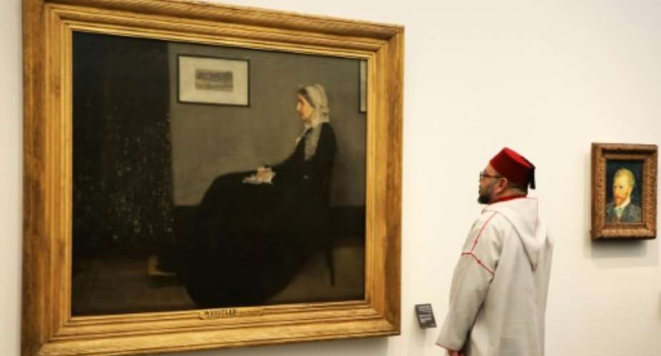 Moroccan King Mohammed VI looks at a painting titled Whistler's Mother by James Abbott McNeill Whistler 1871 at the November 2017 opening of the Louvre Abu Dhabi Museum.  By ludovic MARIN AFPFile
