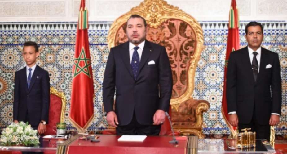 King Mohammed VI C, flanked by Prince Moulay Rachid R and Crown Prince Hassan III L as the King makes a speech to mark the 16th anniversary of his accession to the throne, on July 30, 2015 in Rabat.  By  Moroccan Royal PalaceAFP