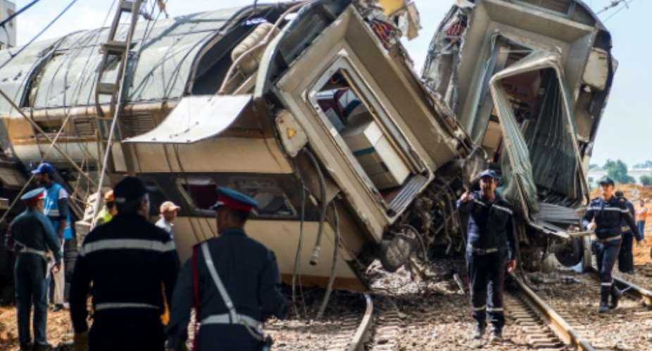Moroccan rescue teams work through the wreckage of a train crash north of Rabat on October 16, 2018.  By FADEL SENNA AFP