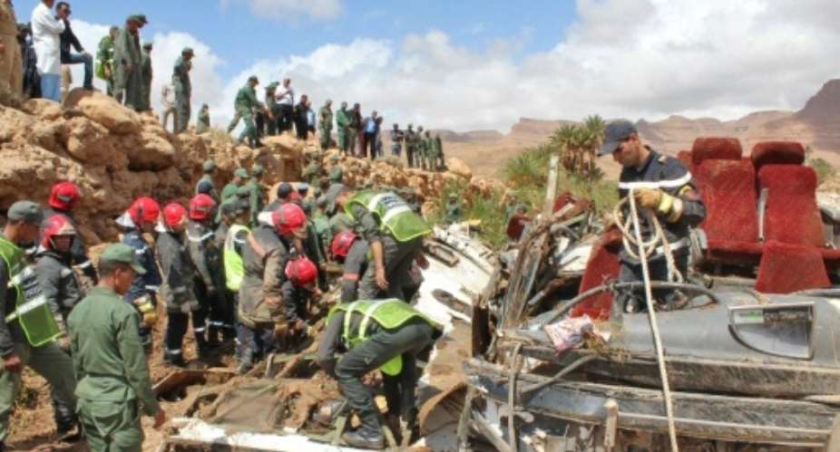 Moroccan rescuers search for bodies after at least 17 people were killed when flood waters overturned their bus in the country's southeast.  By - AFP