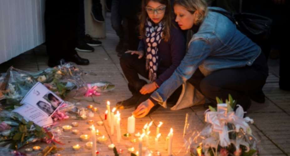 Moroccans lit candles and laid flowers in memory of murdered hikers Louisa Vesterager Jespersen and  Maren Ueland after their killing in December.  By FADEL SENNA AFP