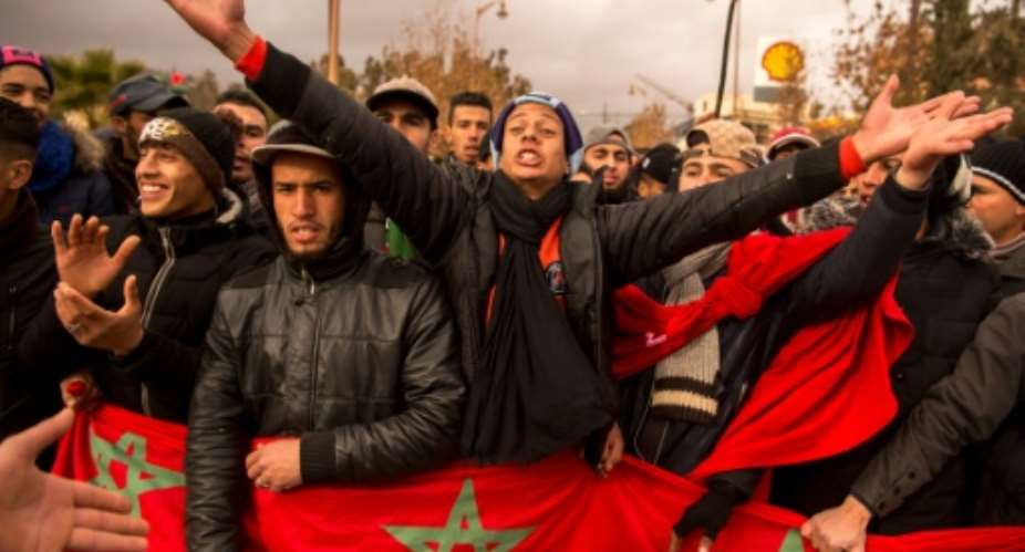 Moroccans shout slogans and wave the national flag during a demonstration in the northeastern city of Jerada on December 27, 2017.  By FADEL SENNA AFP