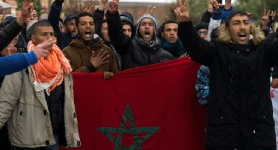 Moroccans take part in a demonstration holding their national flag in the northeastern former mining town of Jerada demanding an alternative economy and the release of jailed activists on March 16, 2018.  By FADEL SENNA AFP