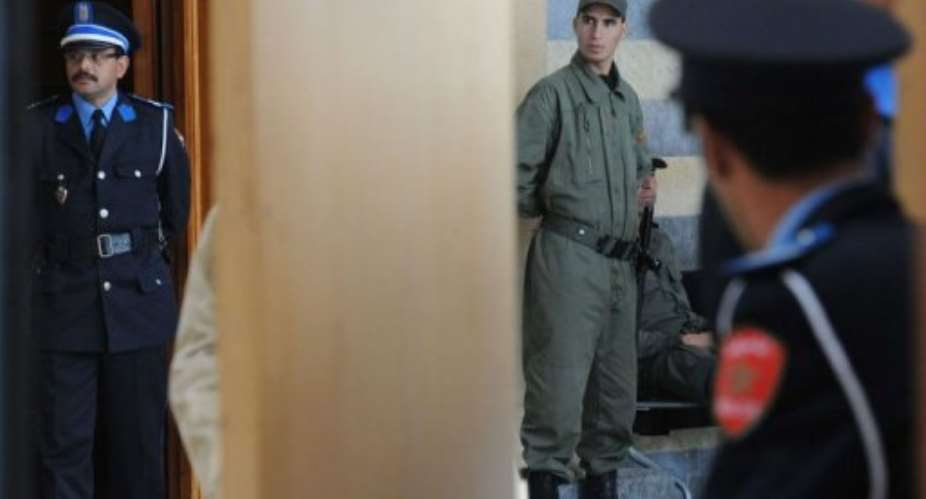 Policemen stand at the entrance of the courtroom.  By Abdelhak Senna (AFP)