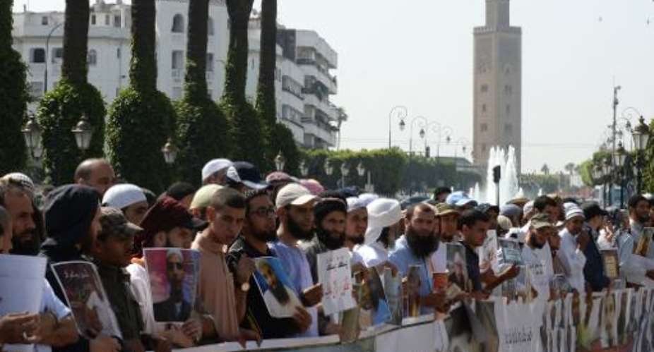 Supporters of jailed Salafists shout slogans and hold placards during a demonstration in front of the parliament in Rabat on May 16, 2014.  By Fadel Senna AFPFile