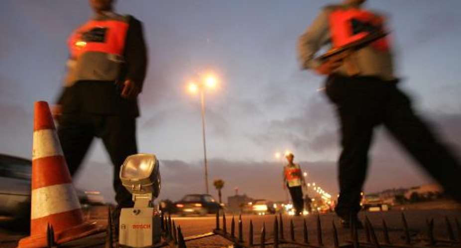 Moroccan policemen stand guard at a checkpoint on July 14, 2007 in Casablanca.  By Abdelhak Senna AFPFile