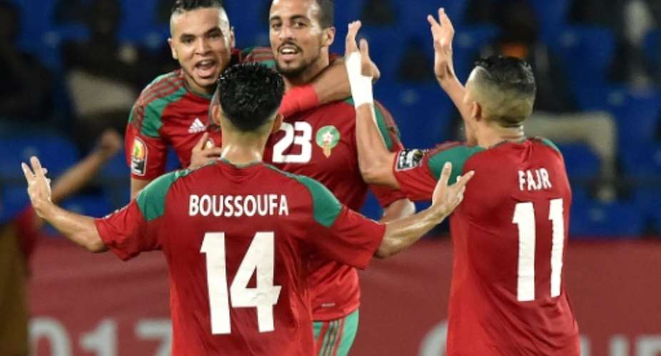 Morocco's midfielder Rachid Alioui C celebrates with teammates after scoring a goal during the 2017 Africa Cup of Nations group C football match between Morocco and Ivory Coast in Oyem on January 24, 2017.  By ISSOUF SANOGO AFP