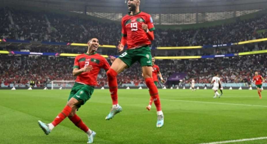 Moroccos policy of persuading dual nationals like Achraf Hakimi (L) to play for them has paid rich dividends.  By PATRICIA DE MELO MOREIRA (AFP)