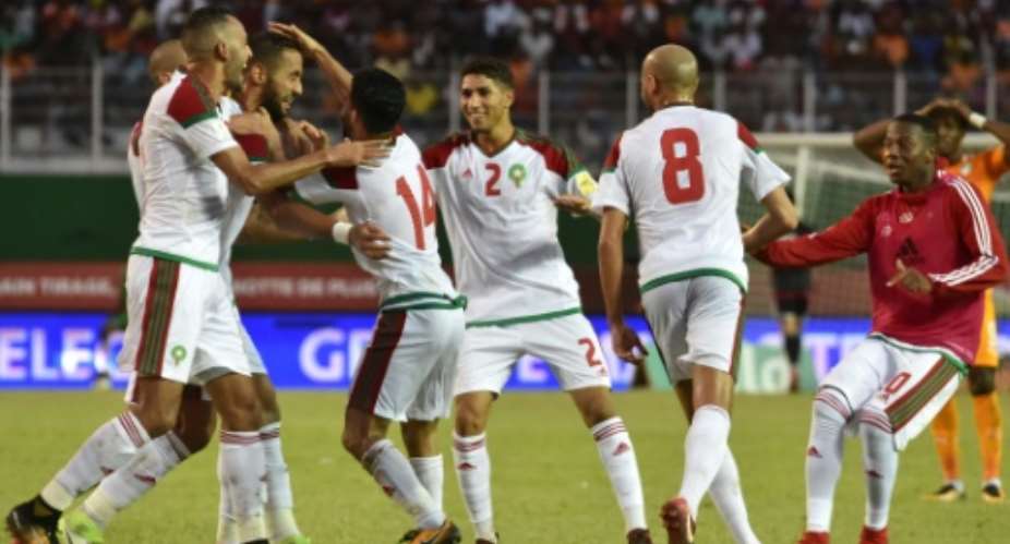 Morocco's team players celebrate a goal against Cote d'Ivoire at the Felix Houphouet-Boigny stadium in Abidjan on November 11, 2017.  By ISSOUF SANOGO AFP