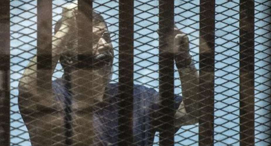 Egypt's ousted Islamist president Mohamed Morsi pictured in the  defendants' cage at a Cairo court on May 8, 2015, during his trial of organising jail breaks during the 2011 uprising that toppled strongman Hosni Mubarak.  By Tarek El-Gabass AFPFile