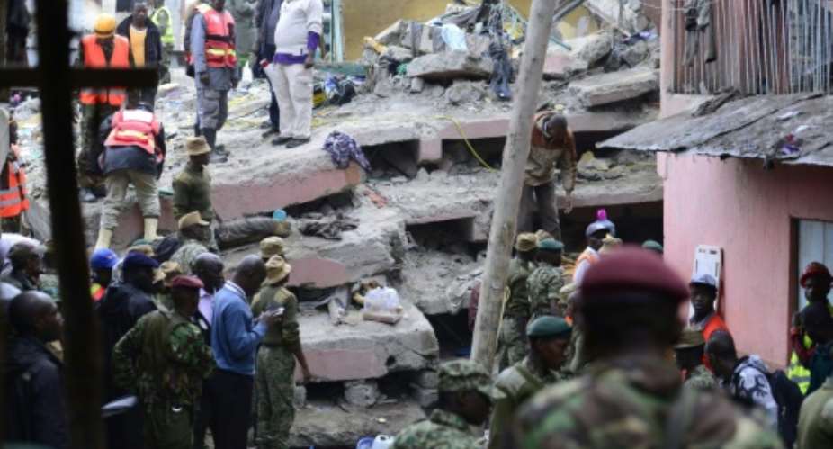 Kenyan security forces and emergency personnel look for survivors under the rubble of a collapsed building in Nairobi on April 30, 2016.  By John Muchacha AFPFile