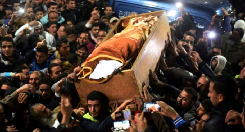 Mourners carry the coffin of Omar Abdel Rahman during his funeral in the village of Jamalia, in the Egyptian province of Dakahlia, on February 22, 2017.  By MOHAMED EL-SHAHED AFP