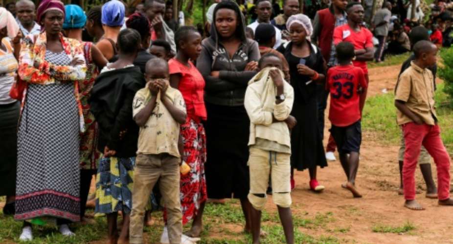 Mourning: The scene in Oicha, in the Beni region, on November 29 after more than two dozen people were hacked to death.  By Bienvenu-Marie BAKUMANYA AFPFile