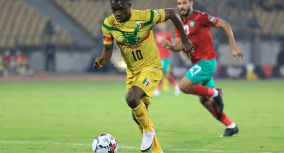 Moussa Kone L of Mali is pursued by Abdelmounaim Boutouil of Morocco during the African Nations Championship final in Yaounde Sunday..  By Daniel BELOUMOU OLOMO AFP