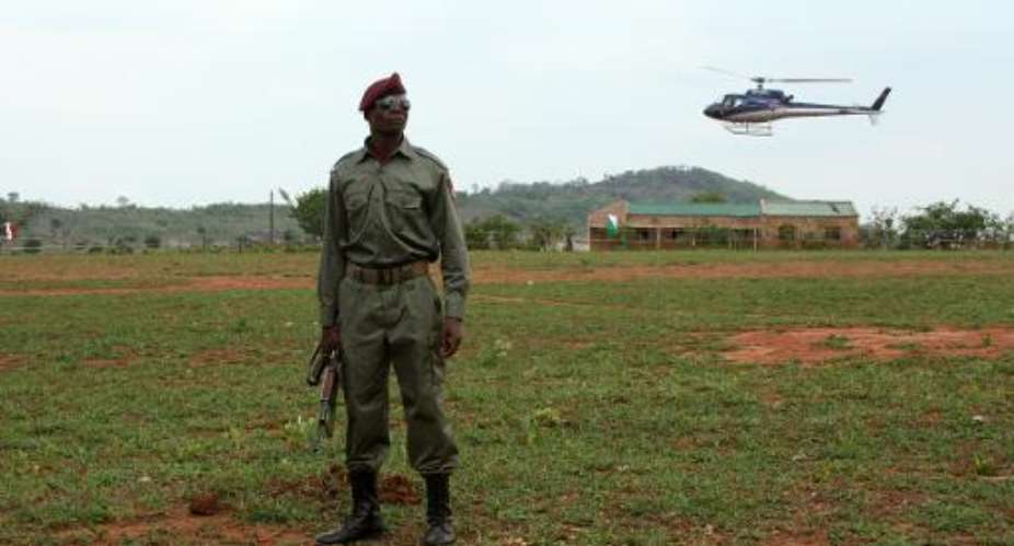 A soldier keeps watch as a helicopter lands in Catandica on October 29, 2013.  By Jinty Jackson (AFP)
