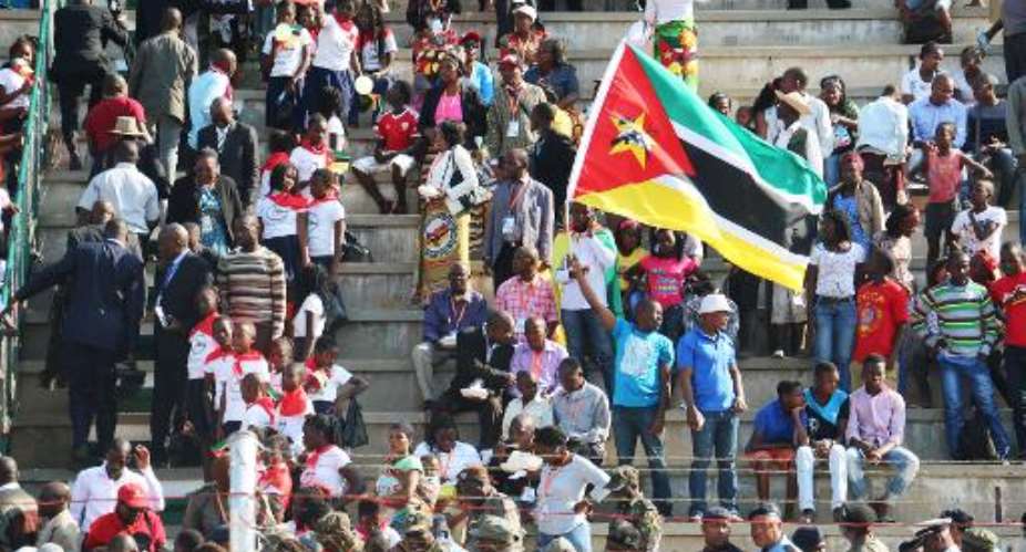 Mozambican people celebrate, some waving Mozambican national flags, during the celebrations for the 40th anniversary of Mozambican independence from Portugal at the Machava stadium on June 25, 2015 in Maputo.  By Adrien Barbier (AFP)