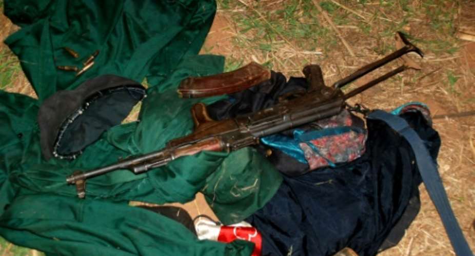 A weapon and clothes belonging to members of former Mozambican rebel movement Renamo lying on the ground in Gorongosa on October 17, 2013.  By Maria Celeste Mac Arthur AFPFile