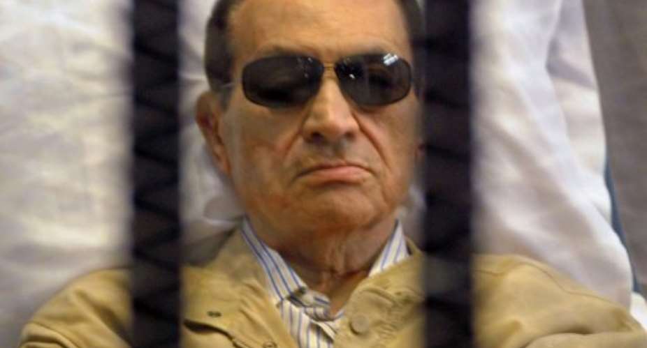 Ousted Egyptian president Hosni Mubarak sits in a cage in court during his verdict hearing in Cairo on June 2, 2012.  By  AFPFile