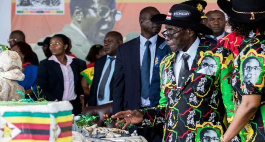 Mugabe celebrated last year with a huge birthday cake and a lavish party.  By Jekesai NJIKIZANA AFPFile