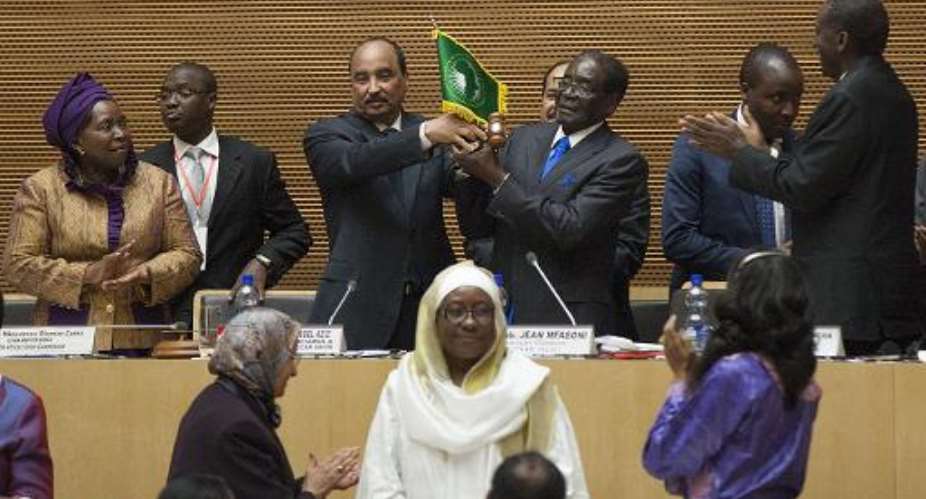 President of Zimbabwe Robert Mugabe R is sworn in to his newly appointed position as Chairman of the African Union on January 30, 2015 in Addis Ababa, Ethiopia.  By Zacharias Abubeker AFPFile