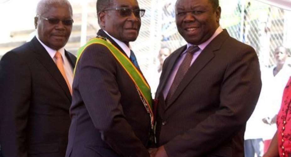 Zimbabwes President Robert Mugabe (left) greets Prime Minister Morgan Tsvangirai in April 2011.  By Jekesai Njikizana (AFP/File)