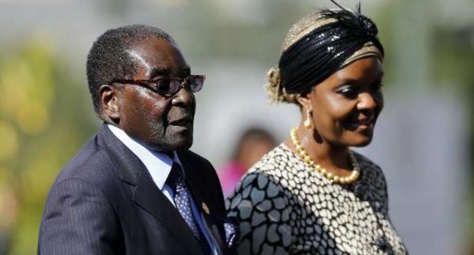 Zimbabwean President Robert Mugabe L arrives with his wife Grace at the Union Buildings in Pretoria on May 24, 2014.  By Siphiwe Sibeko PoolAFPFile