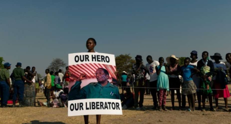Mugabe's body was greeted to a low-key farewell in his home village.  By Jekesai NJIKIZANA AFP