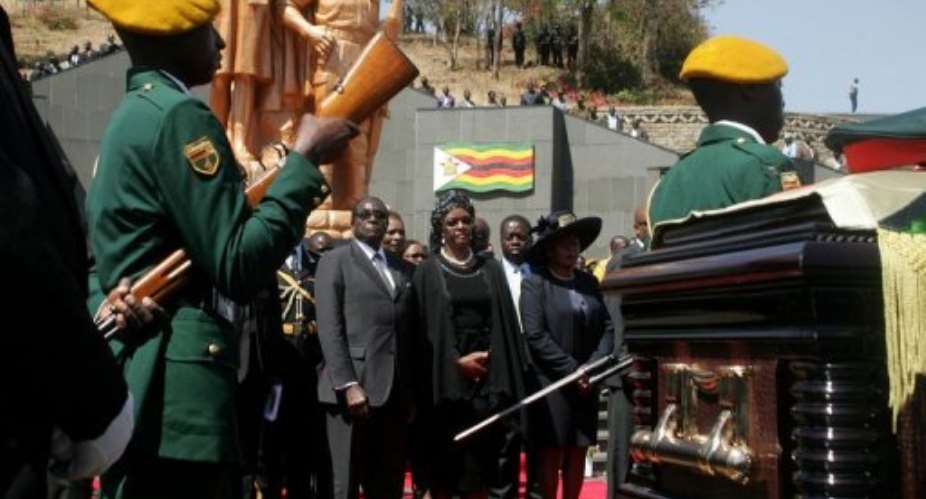 Zimbabwean President Robert Mugabe and his wife Grace attend the burial of Solomon Mujuru.  By Jekesai Njikizana (AFP/File)