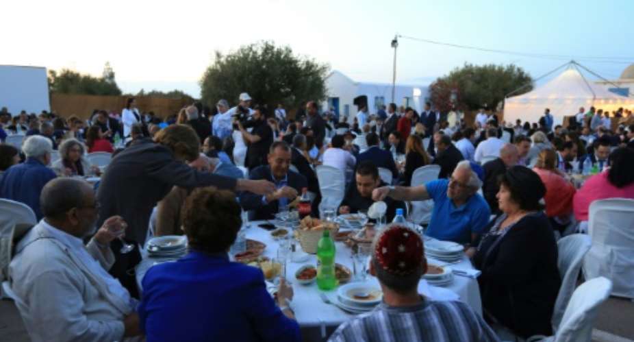 Muslim and Jewish leaders shared a fast-breaking meal on the Tunisian island of Djerba.  By FATHI NASRI AFP