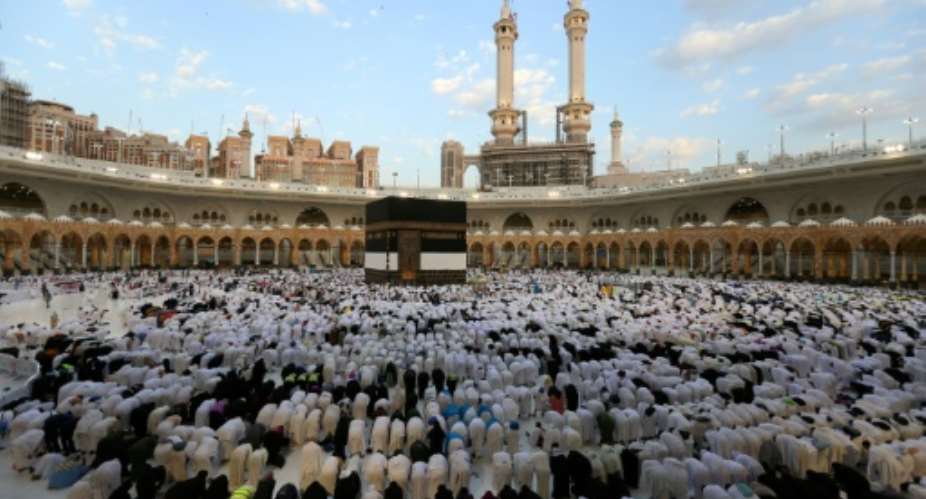 Muslims perform the Eid al-Adha morning prayer around the Kaaba, Islams holiest shrine, at the Grand Mosque in Saudi Arabias holy city of Mecca.  By - (AFP)