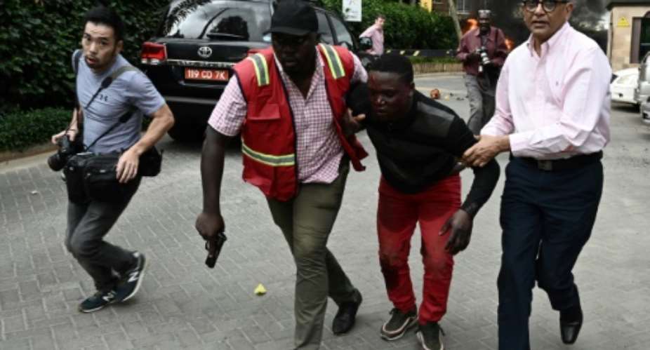 Nairobi attack: An injured man is evacuated from the Dusit2 hotel and office complex.  By SIMON MAINA AFP
