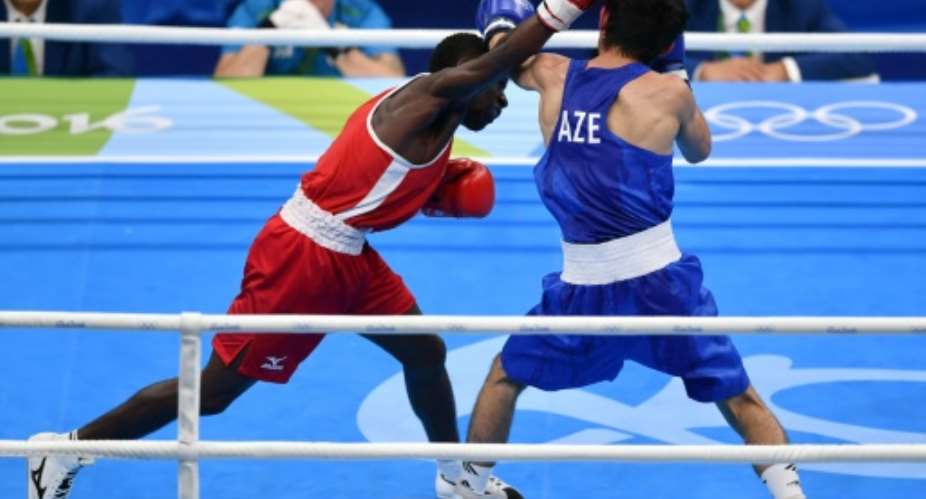 Azerbaijans Rufat Huseynov (R) fights Namibias Mathias Tulyoongeleni Hamunyela during the mens light fly (46-49kg) match on August 6, 2016.  By Yuri Cortez (AFP)