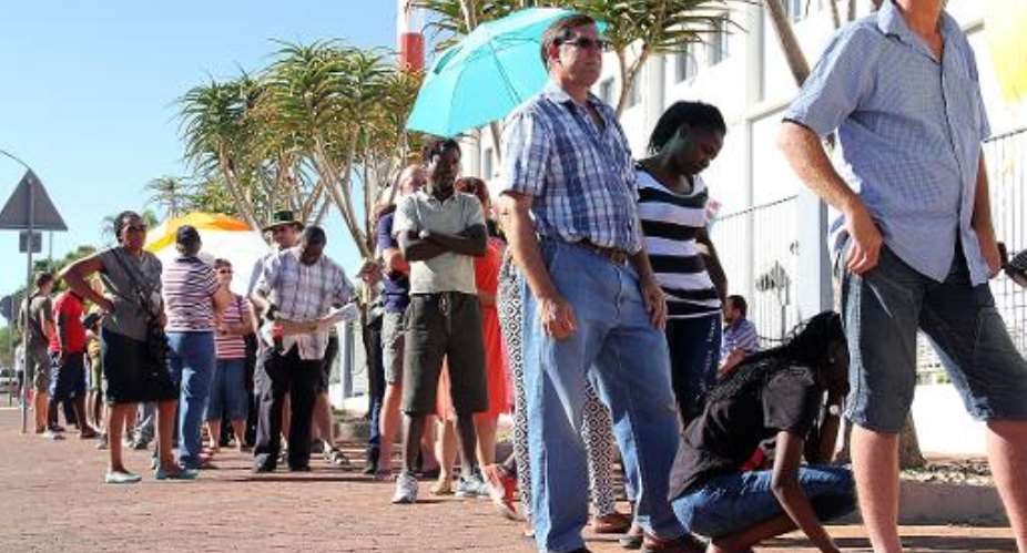 Namibians queue outside a polling station to vote in a general election in Windhoek on November 28, 2014.  By Jordaania Andima AFPFile