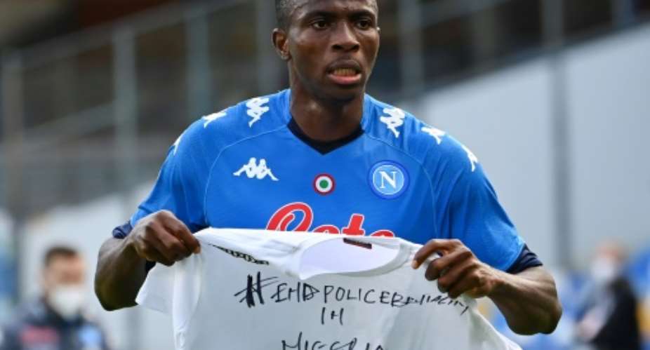 Napoli forward Victor Osimhen holds up a t-shirt 'End police brutality in Nigeria'..  By alberto pizzoli AFP