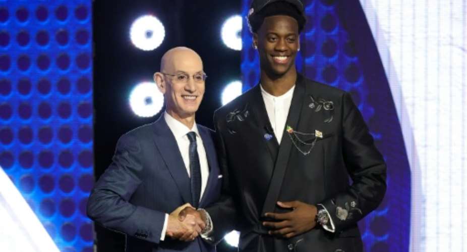 NBA commissioner Adam Silver shakes hands with AJ Dybantsa after he is chosen by the Washington Wizards with the top pick in the NBA Draft.  By Arturo Holmes (GETTY IMAGES NORTH AMERICA/AFP)