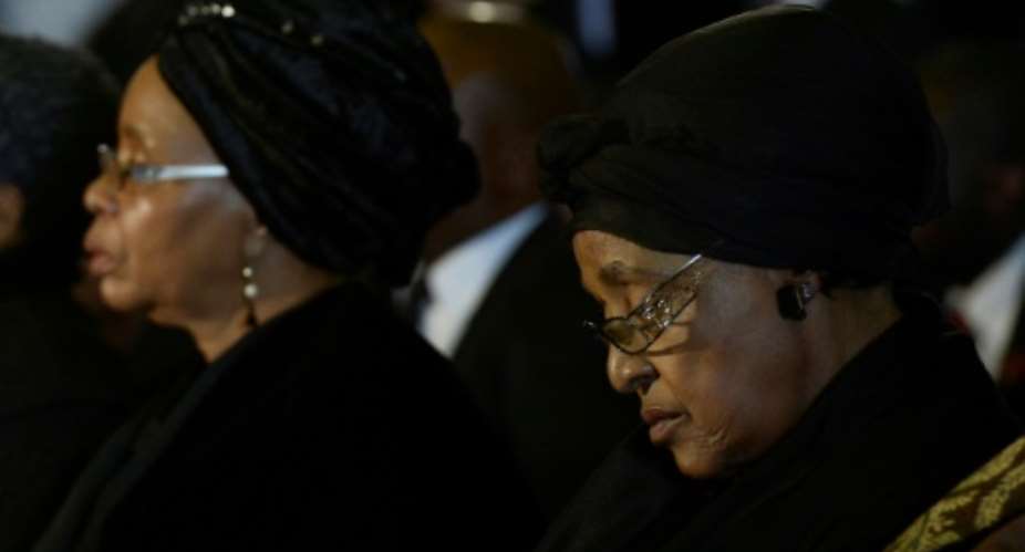 Nelson Mandelas third wife, Graca Machel, left, and his second wife Winnie Mandela Madikizela attend a farewell service for the former South African president in 2013.  By STEPHANE DE SAKUTIN (AFP/File)
