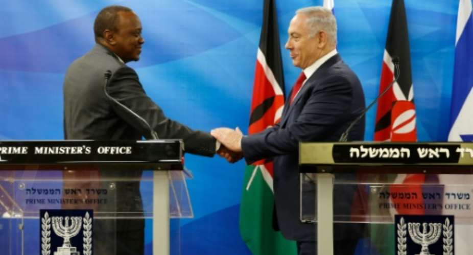 Kenya's President Uhuru Kenyatta left shakes hands with Israeli Prime Minister Benjamin Netanyahu in Jerusalem on February 23, 2016.  By Amir Cohen PoolAFP