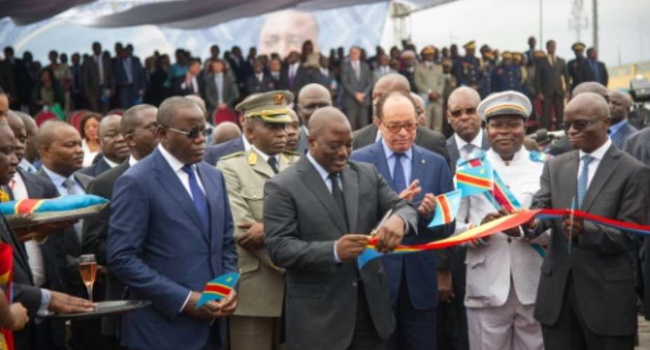 DR Congo President Joseph Kabila (centre) cuts the ribbon to officially launch the maiden flight of Congo Airways on October 9, 2015 at Kinshasa Airport.  By Junior Kannah (AFP)
