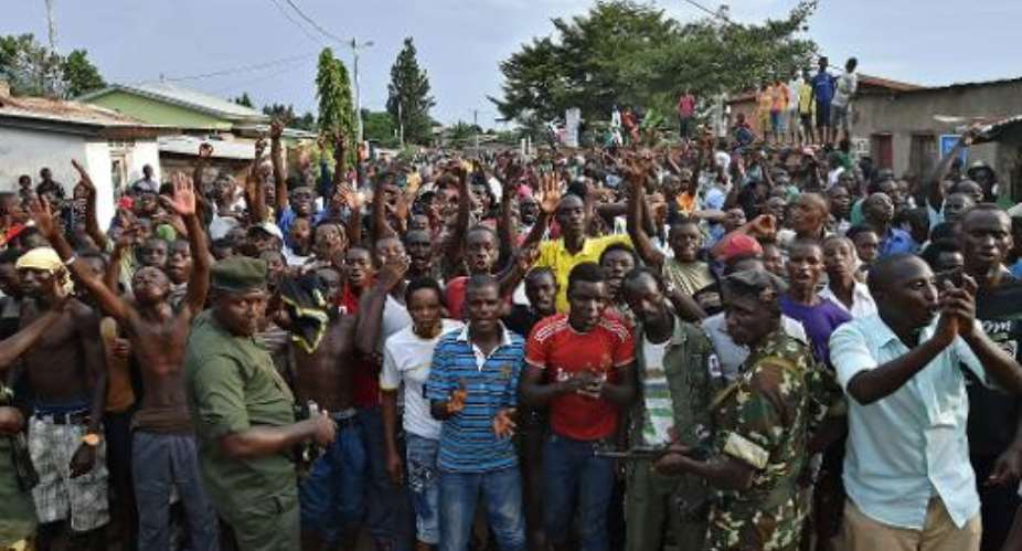 Soldiers try to contain protestors during a demonstration against the Burundian presidents third term in the Musaga neighborhood of Bujumbura on May 20, 2015.  By Carl de Souza (AFP)