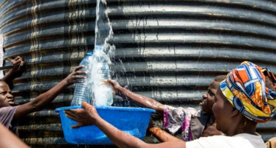 New Congolese refugees get water from a tank at a refugee settlement in Kyangwali, Uganda, on February 16, 2018.  By SUMY SADURNI AFPFile
