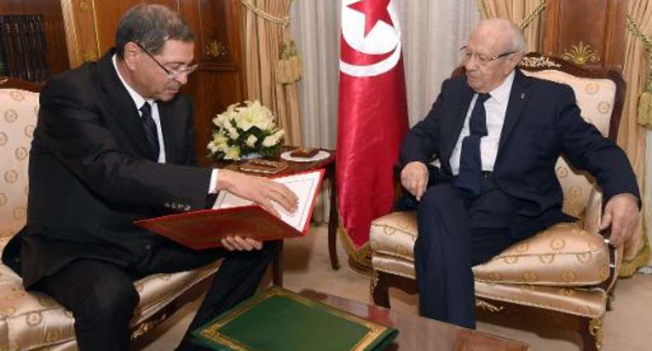 Tunisia's nominated Prime Minister Habib Essid L presents his cabinet to Tunisian President Beji Caid Essebsi on January 23, 2015 in Carthage Palace in Tunis.  By Fethi Belaid AFP