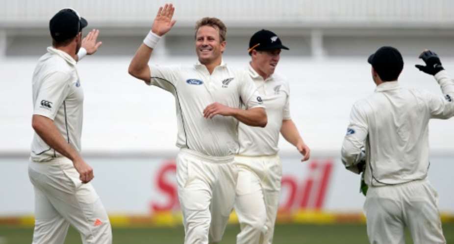 New Zealand bowler Neil Wagner 2L celebrates the dismissal of South Africa batsman JP Duminy not pictured during the first Test at the Sahara Cricket stadium in Durban on August 19, 2016.  By Gianluigi Guercia AFP
