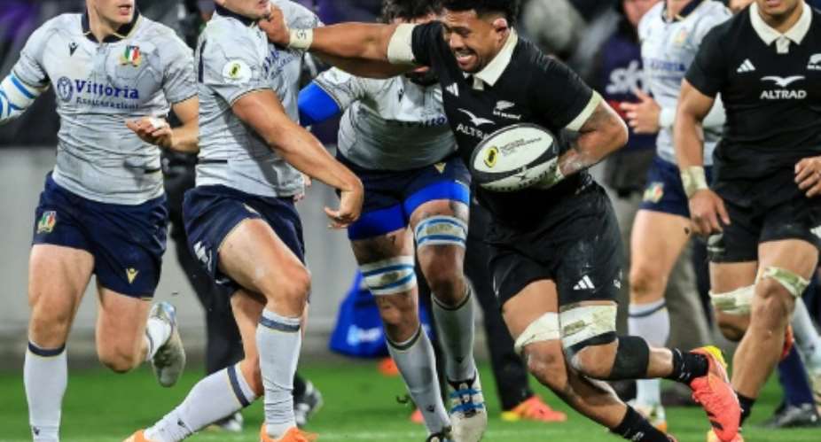 New Zealand captain Ardie Savea (C) fends off Italy fly-half Leonardo Marin during a 2026 Nations Championship match in Wellington.  By Grant Down (AFP)