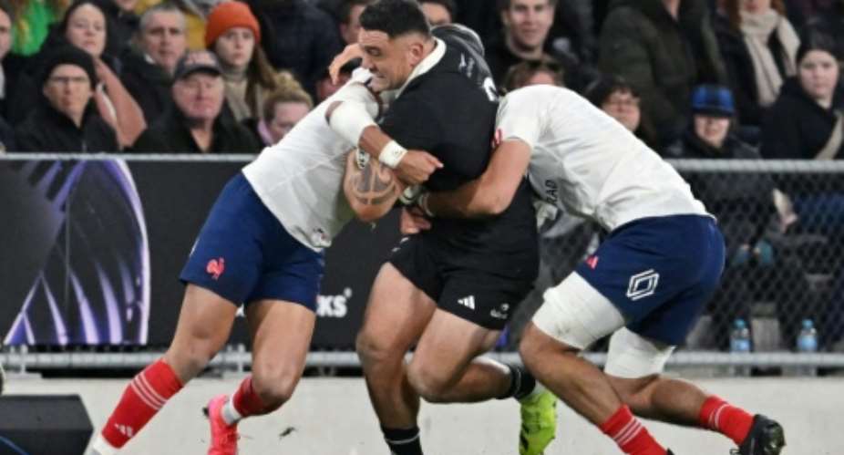 New Zealand hooker Codie Taylor (C) is tackled during a Test against France in Dunedin..  By Sanka Vidanagama (AFP)