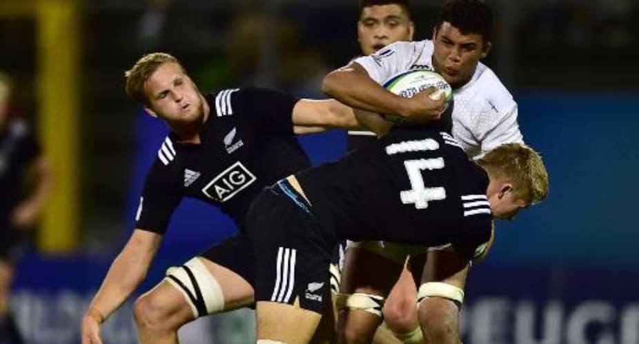 New Zealands Jack Goodhue (R) tackles Englands Lewis Ludlam (2nd R) during the World Rugby U20 Championship final match on June 20, 2015 at the Giovanni Zini stadium in Cremona.  By Giuseppe Cacace (AFP)
